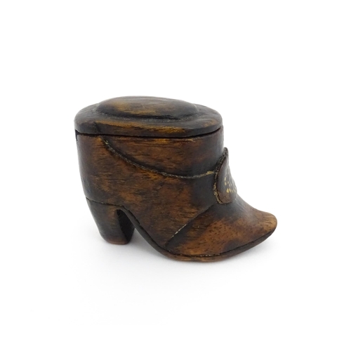 1197 - Treen : A 19thC Continental shoe snuff box of boot form with sliding lid and brass studwork detail t... 