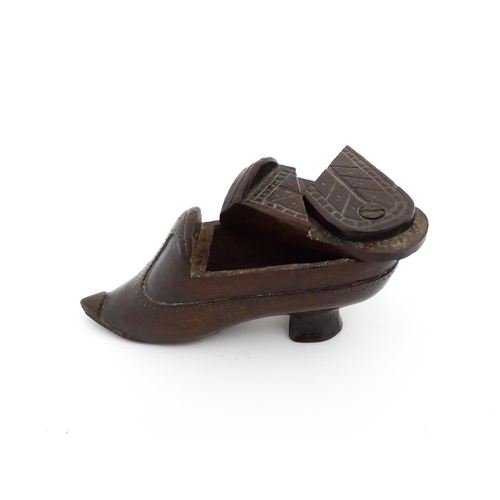 1199 - Treen : A 19thC novelty puzzle shoe snuff box of heeled shoe form with carved decoration. Approx. 4