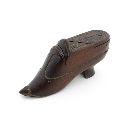 1199 - Treen : A 19thC novelty puzzle shoe snuff box of heeled shoe form with carved decoration. Approx. 4