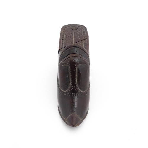 1199 - Treen : A 19thC novelty puzzle shoe snuff box of heeled shoe form with carved decoration. Approx. 4