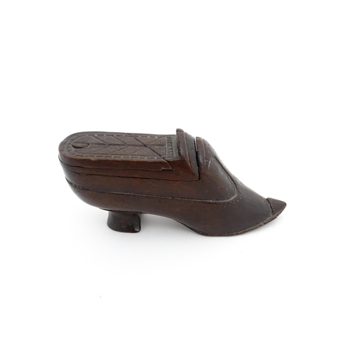 1199 - Treen : A 19thC novelty puzzle shoe snuff box of heeled shoe form with carved decoration. Approx. 4