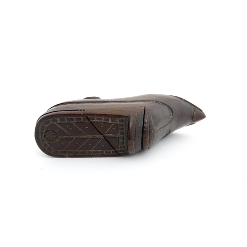 1199 - Treen : A 19thC novelty puzzle shoe snuff box of heeled shoe form with carved decoration. Approx. 4