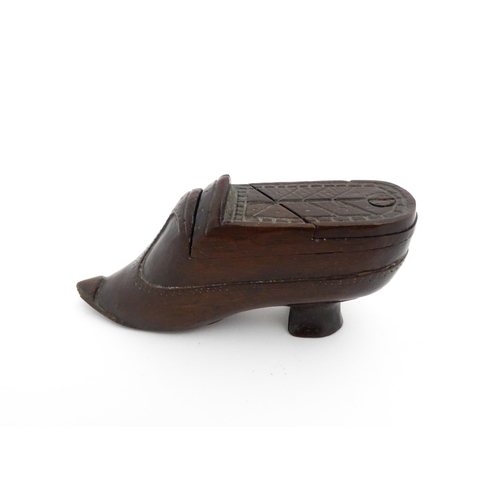 1199 - Treen : A 19thC novelty puzzle shoe snuff box of heeled shoe form with carved decoration. Approx. 4