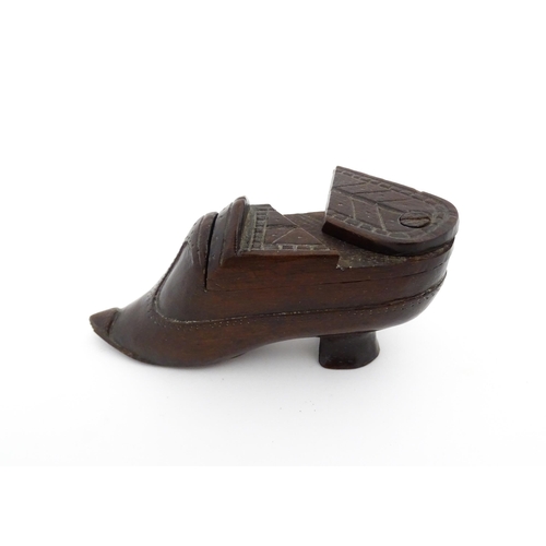 1199 - Treen : A 19thC novelty puzzle shoe snuff box of heeled shoe form with carved decoration. Approx. 4