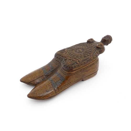 1200 - Treen : A 19thC shoe snuff box with chip carved decoration and carved figural detail to lid. Possibl... 