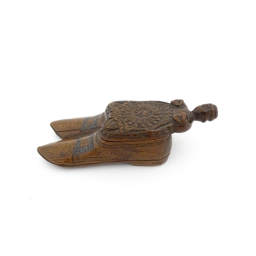 1200 - Treen : A 19thC shoe snuff box with chip carved decoration and carved figural detail to lid. Possibl... 