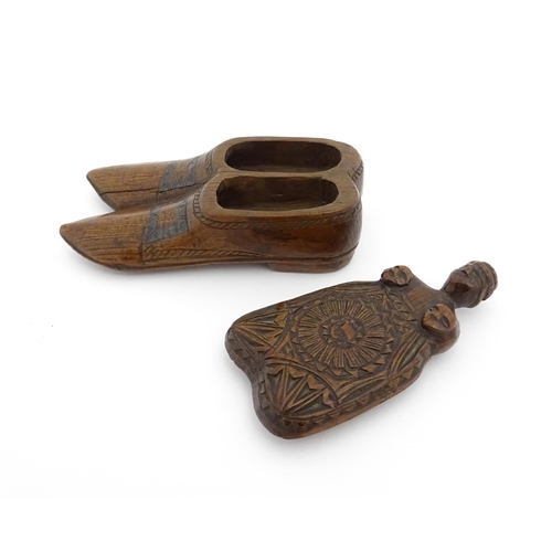 1200 - Treen : A 19thC shoe snuff box with chip carved decoration and carved figural detail to lid. Possibl... 