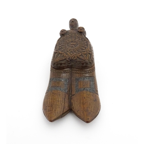 1200 - Treen : A 19thC shoe snuff box with chip carved decoration and carved figural detail to lid. Possibl... 