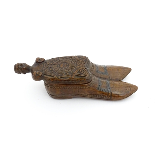 1200 - Treen : A 19thC shoe snuff box with chip carved decoration and carved figural detail to lid. Possibl... 