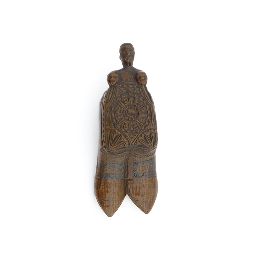 1200 - Treen : A 19thC shoe snuff box with chip carved decoration and carved figural detail to lid. Possibl... 