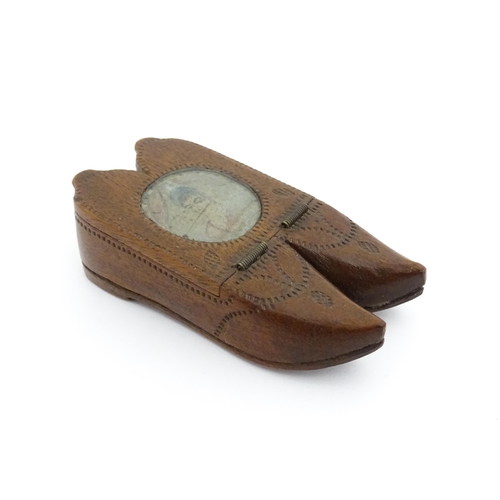 1202 - Treen : A 19thC Dutch shoe snuff box of double shoe form with chip carved decoration and inlaid circ... 