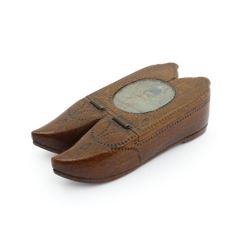 1202 - Treen : A 19thC Dutch shoe snuff box of double shoe form with chip carved decoration and inlaid circ... 