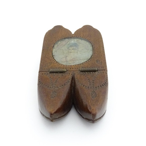 1202 - Treen : A 19thC Dutch shoe snuff box of double shoe form with chip carved decoration and inlaid circ... 