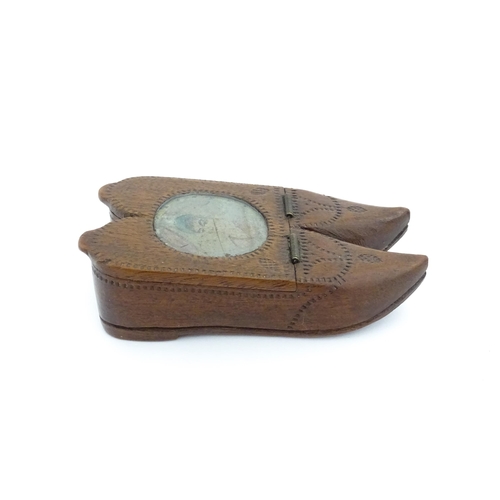 1202 - Treen : A 19thC Dutch shoe snuff box of double shoe form with chip carved decoration and inlaid circ... 