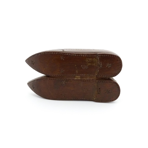 1202 - Treen : A 19thC Dutch shoe snuff box of double shoe form with chip carved decoration and inlaid circ... 