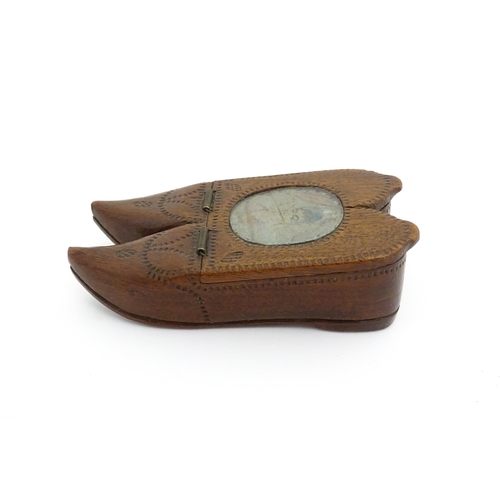 1202 - Treen : A 19thC Dutch shoe snuff box of double shoe form with chip carved decoration and inlaid circ... 