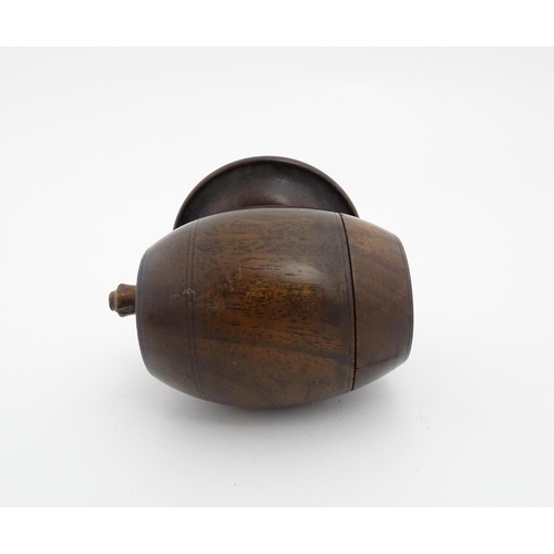 1210 - A 20thC carved coconut formed as a basket with geometric detail. Together with treen string box of b... 