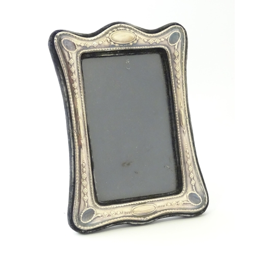 538 - An easel back photograph frame with silver surround hallmarked London 1988, maker Keyford Frames Ltd... 