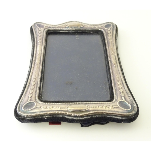 538 - An easel back photograph frame with silver surround hallmarked London 1988, maker Keyford Frames Ltd... 