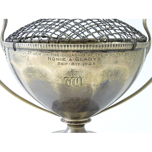 544 - A silver pedestal twin handled trophy cup / rose bowl hallmarked Birmingham 1921, maker Collingwood ... 