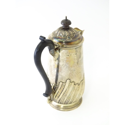 549 - A silver coffee pot with fluted decoration and ebonised handle hallmarked Birmingham 1907, maker Jos... 