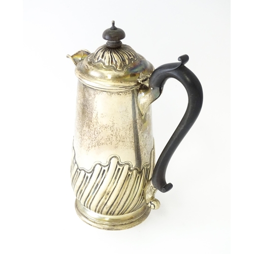 549 - A silver coffee pot with fluted decoration and ebonised handle hallmarked Birmingham 1907, maker Jos... 