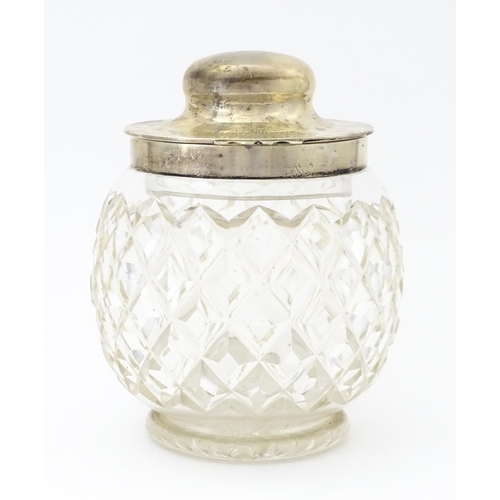 550 - A large cut glass jar with glass stopper and silver lid and mounts hallmarked Birmingham 1912, maker... 