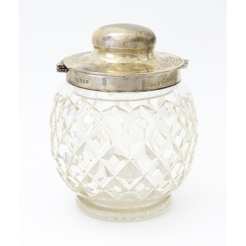 550 - A large cut glass jar with glass stopper and silver lid and mounts hallmarked Birmingham 1912, maker... 