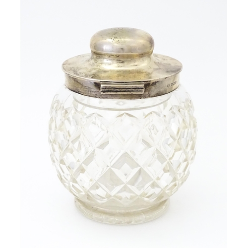 550 - A large cut glass jar with glass stopper and silver lid and mounts hallmarked Birmingham 1912, maker... 