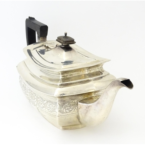 552 - A silver teapot with engraved decoration hallmarked London 1913, maker S. W. Smith & Co. Approx. 5 1... 