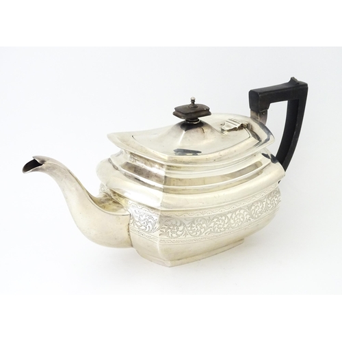 552 - A silver teapot with engraved decoration hallmarked London 1913, maker S. W. Smith & Co. Approx. 5 1... 