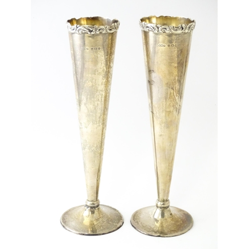 554 - A pair of silver vases of conical form hallmarked Birmingham 1923, maker Wilmot Manufacturing Co. Ap... 