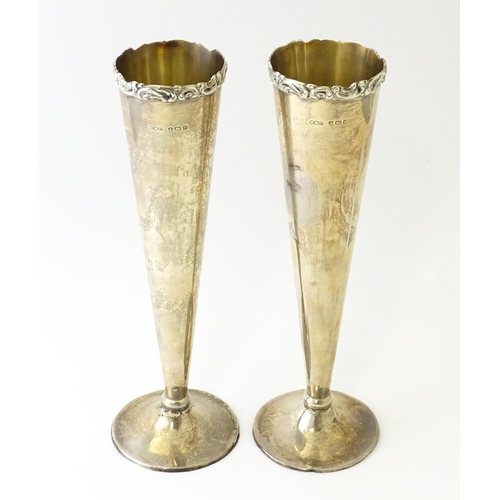 554 - A pair of silver vases of conical form hallmarked Birmingham 1923, maker Wilmot Manufacturing Co. Ap... 