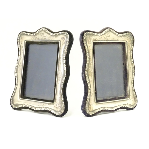 555 - A pair of easel back photograph frames with silver surrounds hallmarked London 1988, maker Keyford F... 