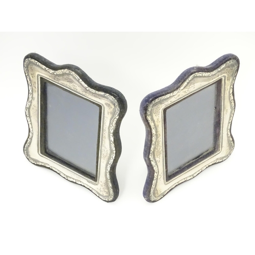 555 - A pair of easel back photograph frames with silver surrounds hallmarked London 1988, maker Keyford F... 