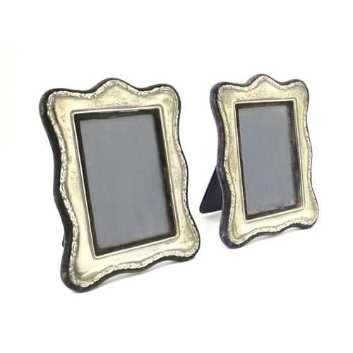 555 - A pair of easel back photograph frames with silver surrounds hallmarked London 1988, maker Keyford F... 