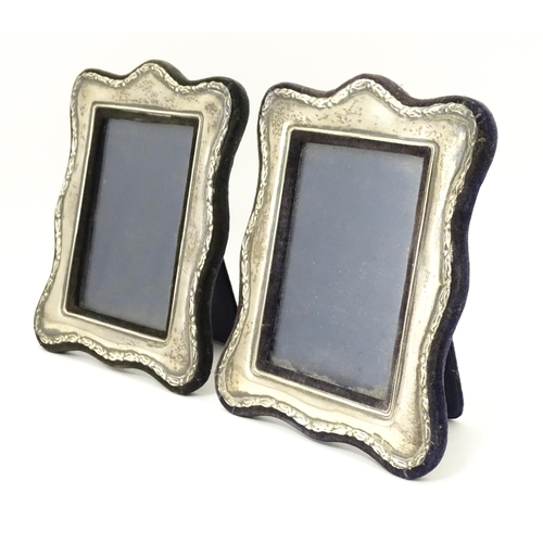 555 - A pair of easel back photograph frames with silver surrounds hallmarked London 1988, maker Keyford F... 