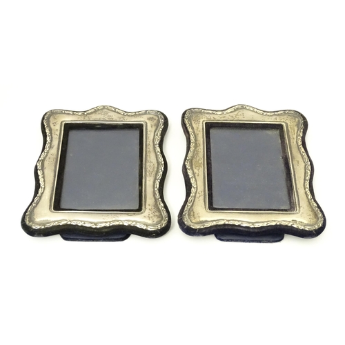 555 - A pair of easel back photograph frames with silver surrounds hallmarked London 1988, maker Keyford F... 