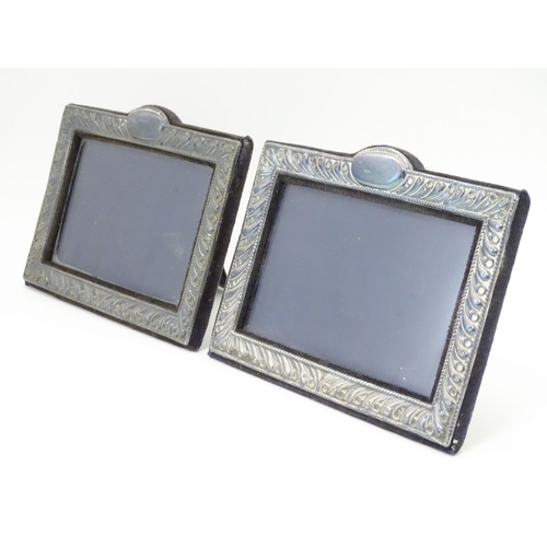 556 - A pair of easel back photograph frames with silver surrounds hallmarked London 1988, maker Keyford F... 