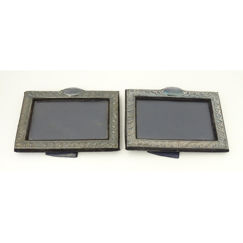 556 - A pair of easel back photograph frames with silver surrounds hallmarked London 1988, maker Keyford F... 