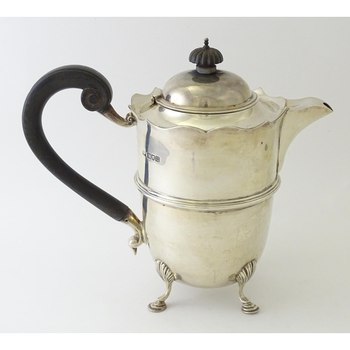 557 - A silver coffee pot with banded detail and ebonised handle, hallmarked London 1915, maker Mappin & W... 