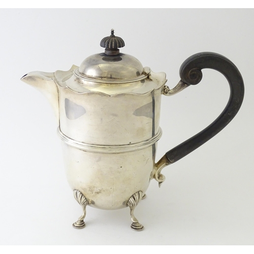 557 - A silver coffee pot with banded detail and ebonised handle, hallmarked London 1915, maker Mappin & W... 