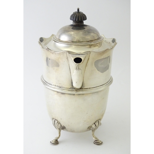 557 - A silver coffee pot with banded detail and ebonised handle, hallmarked London 1915, maker Mappin & W... 