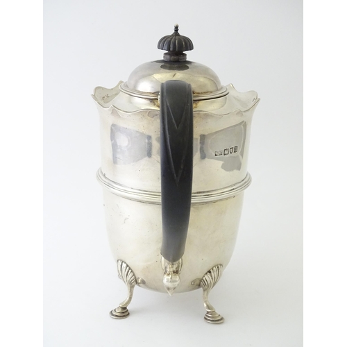 557 - A silver coffee pot with banded detail and ebonised handle, hallmarked London 1915, maker Mappin & W... 