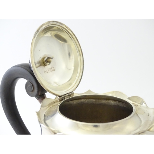 557 - A silver coffee pot with banded detail and ebonised handle, hallmarked London 1915, maker Mappin & W... 