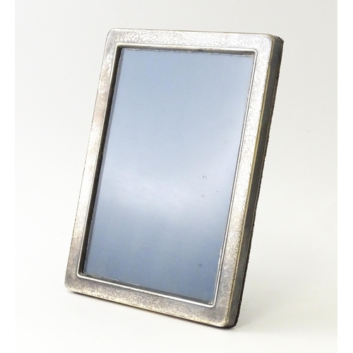 559 - An easel back photograph frame with silver surround hallmarked Sheffield 1992, maker Carrs of Sheffi... 