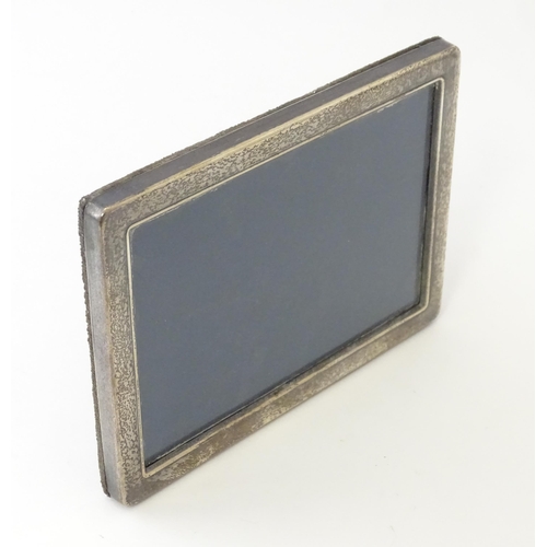 559 - An easel back photograph frame with silver surround hallmarked Sheffield 1992, maker Carrs of Sheffi... 