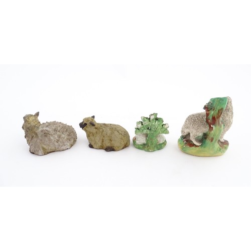 197 - Four ceramic models of sheep to include a 19thC Staffordshire hollow base lamb with bocage, a Staffo... 