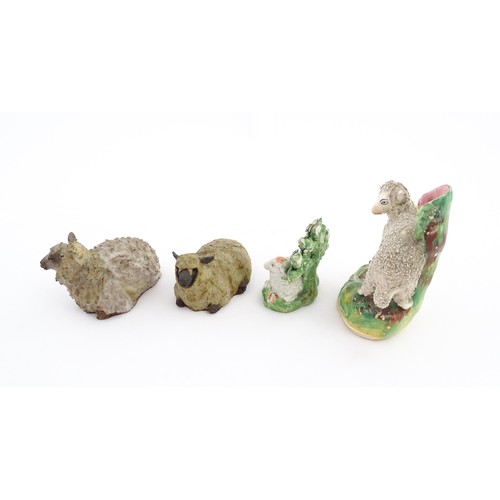 197 - Four ceramic models of sheep to include a 19thC Staffordshire hollow base lamb with bocage, a Staffo... 