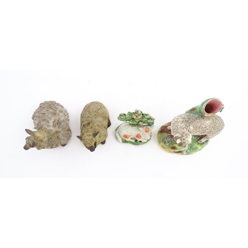 197 - Four ceramic models of sheep to include a 19thC Staffordshire hollow base lamb with bocage, a Staffo... 